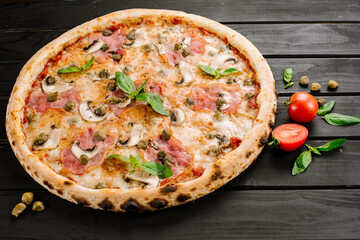 Tasty fresh pizza with ingredients on wooden background