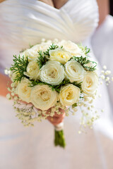 A bride holding a wedding bouquet close-up