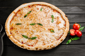 Fresh tasty cheese pizza on wooden background