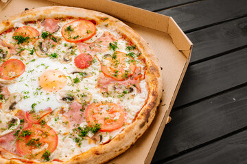 Fresh carbonara pizza with scrambled egg on wooden background