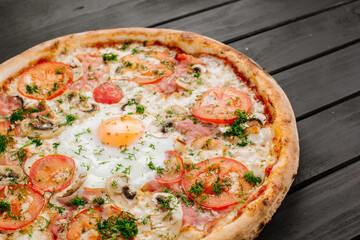 Fresh carbonara pizza with scrambled egg on wooden background