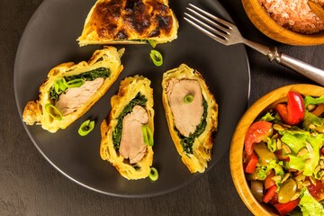 Roast pork tenderloin coated with dough and spinach. Diet food. Home cooking. Pork tenderloin.