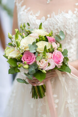 Bouquet in the hands of the bride of fresh roses