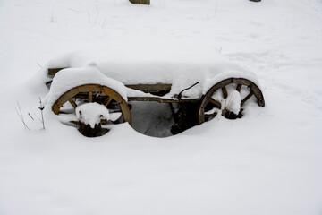wooden vintage items outdoors in the park under the snow