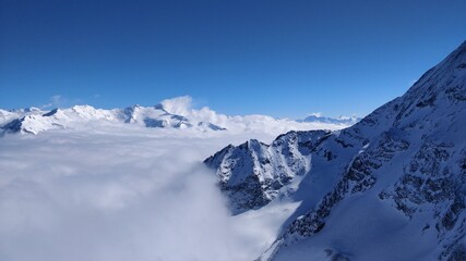 Snowy mountains above the clouds