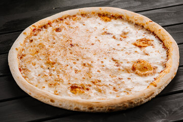 Tasty fresh cheese pizza on wooden background
