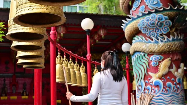 4K Hand of woman hit row bells in buddhist temple