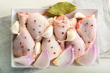 Raw chicken legs with vegetables for cooking