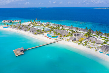Aerial photo of beautiful Maldives paradise tropical beach. Amazing view, blue turquoise lagoon water, palm trees and white sandy beach. Luxury travel vacation destination. Sunny aerial landscape