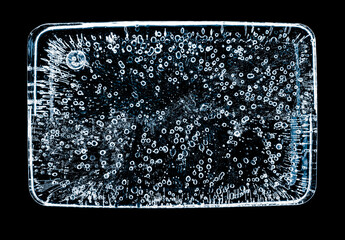 Ice block with air bubbles, isolated on black background.
