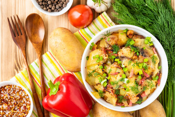 Tartiflette with vegetables and bacon on a wooden background. Top view.