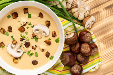 Cream soup of chestnuts on a wooden background. Top view.