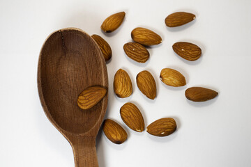 nuts in spoon on white isolated background with copy space