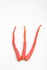 Fresh red carrot bunch on white background