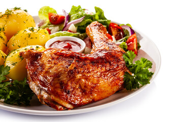 Roast chicken leg with boiled potatoes on white background

