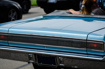 Muscle car rear details, riding on street.