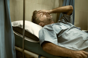 dramatic artistic hospital portrait of attractive and scared man infected by covid19 -  adult male...