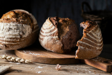 Fresh broken bread on a wooden table