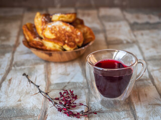 Hot pancakes in a deep plate and berry compote glass mug
