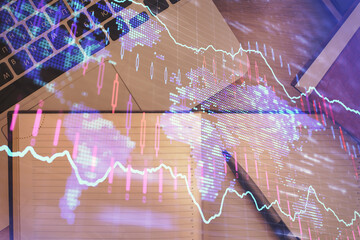 Stock market chart and top view computer on the table background. Double exposure. Concept of...