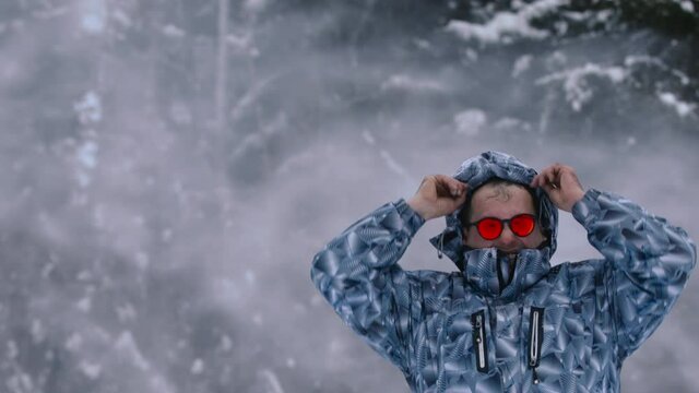 Man stands alone against white snowstorm and snow storm, a snowfall.