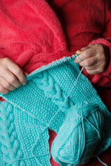 Old womans hands knitting. Blurred image. Keep calm concept. Vertical image.