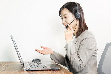 Woman wearing a headset and having a web conference