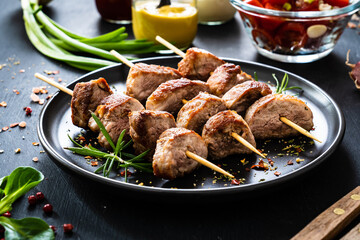 Skewers - grilled pork meat with vegetables on wooden background table
