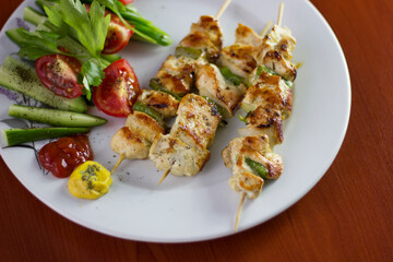 Chicken shish kebab, grilled chicken with greens and tomato