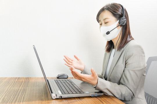 Woman Wearing A Headset With Mask And Having A Web Conference