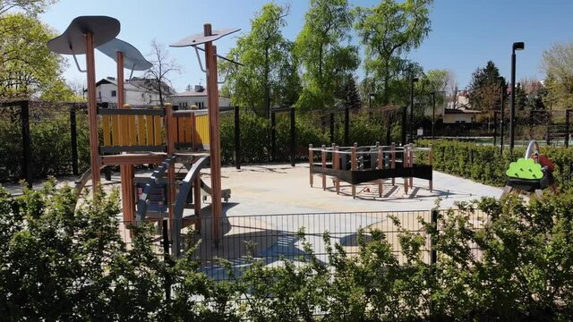 Aerial shot of the empty kids' playground in the deserted city park during Covid-19 lockdown