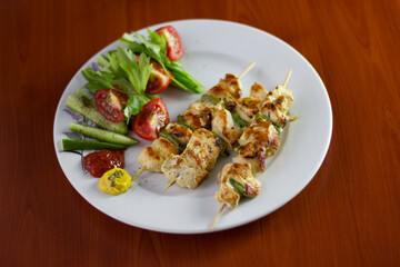 Chicken shish kebab, grilled chicken with greens and tomato