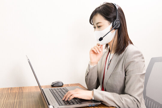 Woman Wearing A Headset With Mask And Having A Web Conference