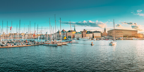 Stockholm, Sweden. Scenic Famous Panoramic View Of Embankment In Old Town Of Stockholm In Sunset Lights. Jetty With Many Moored Yachts. Popular Destination Scenic Place. Panorama