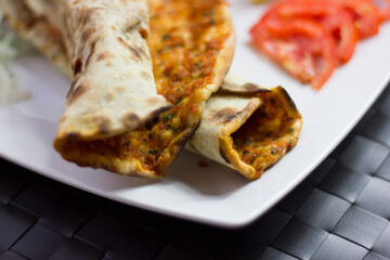 Traditional Turkish pizza (lahmacun) in a white plate