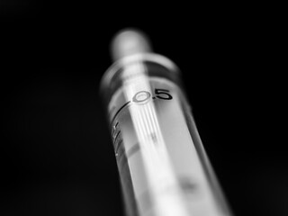 black and white closeup of a syringe
