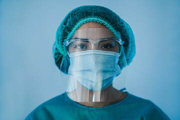 Portrait of young latin nurse work inside hospital during coronavirus period - Woman medical worker...