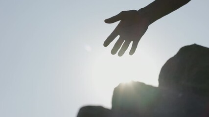 Group of tourists lend helping hand while climbing to top of mountain.Helping hand hiking get help friend from man in a dangerous situation to hike in the mountains.