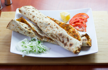 Traditional Turkish pizza (lahmacun) in a white plate