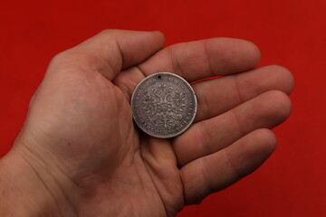 Old Russian silver coin one ruble in hand