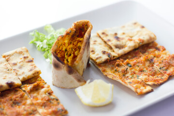 Traditional Turkish pizza (lahmacun) in a white plate