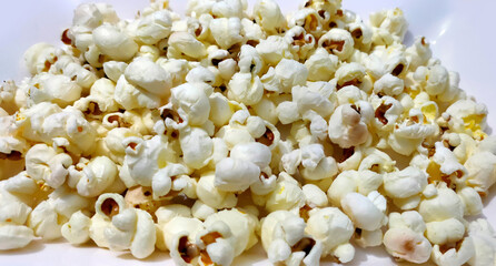 Heap of delicious popcorn, isolated on white background.