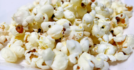 Heap of delicious popcorn, isolated on white background.
