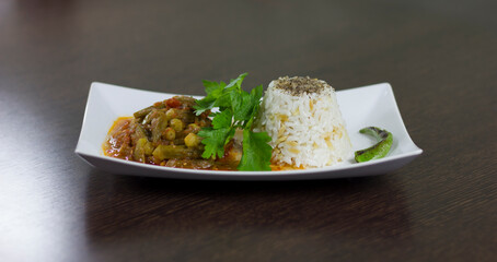 Okra with rice and parsley in a white plate