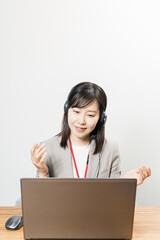 Woman wearing a headset and having a web conference