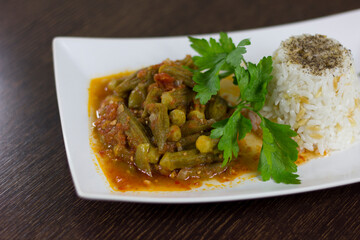 Okra with rice and parsley in a white plate
