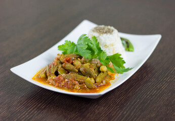 Okra with rice and parsley in a white plate