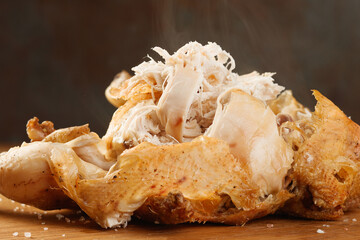 Roasted Chicken on a wooden board with a steam, shallow depth of field