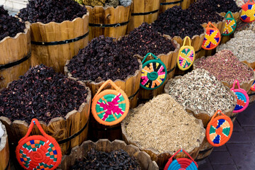 Natural dry hibiscus tea in the wooden baskets on the street market