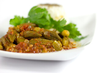 Okra with rice and parsley in a white plate